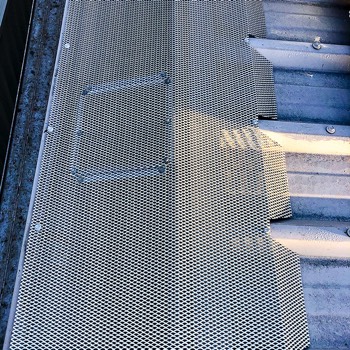  Access hatch in Gutter Guard mesh on a box gutter. 